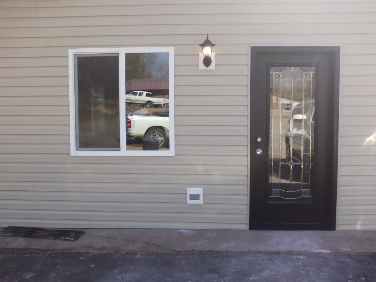 New siding, window and entry door on the side of an addition in Ulster