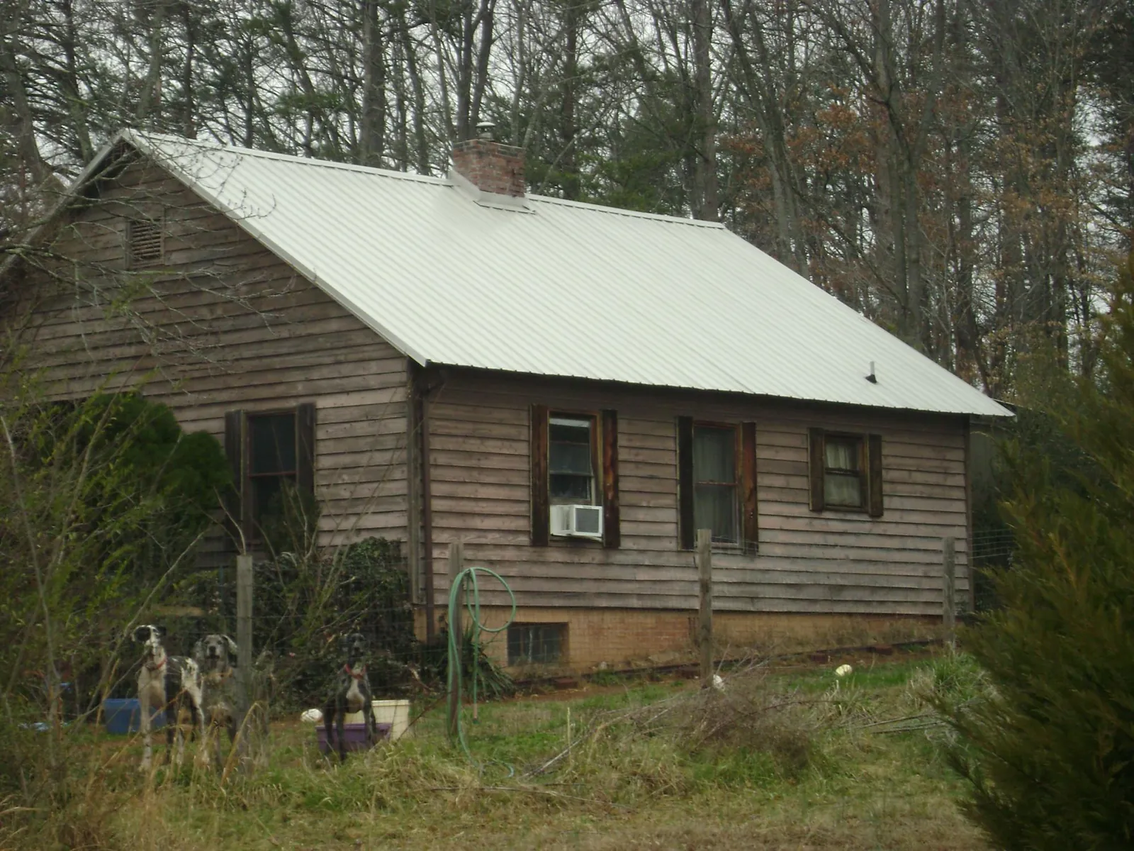 White metal roof on an old wood sided farmhouse, from a Metal Roof Installation job in Ulster